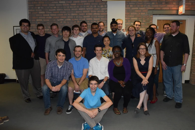 a group of people standing in a room with the men