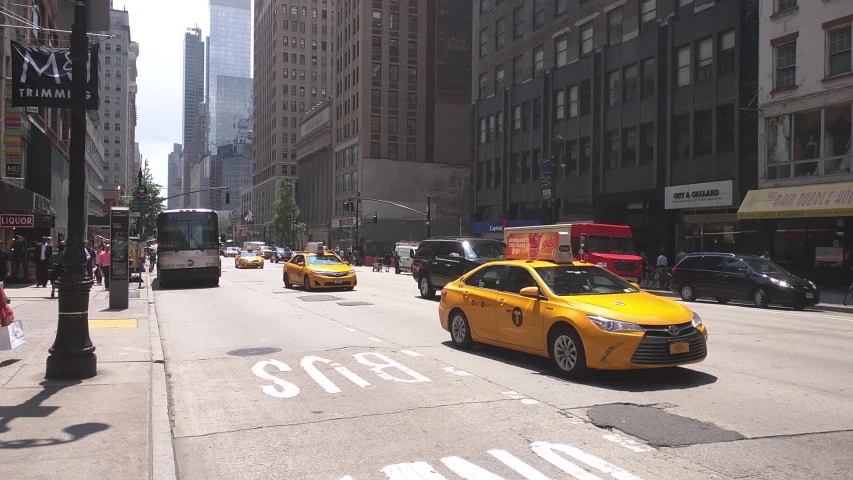 the city streets are busy with yellow taxis