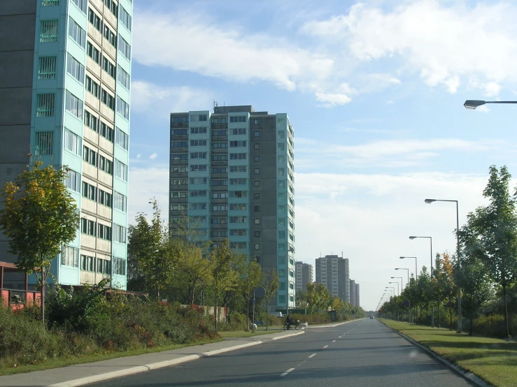 a car is driving down a road with buildings