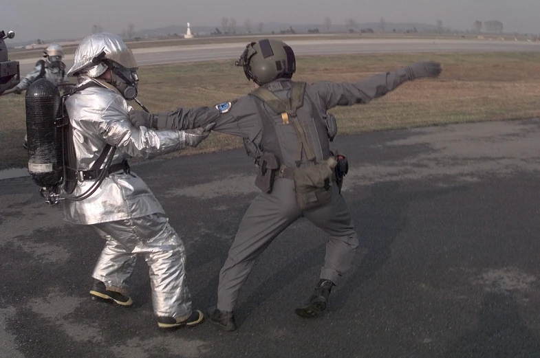 two people dressed as astronauts playing with a helicopter