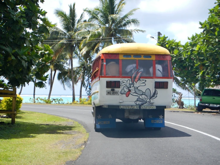 a bus with a painted face is driving down the road