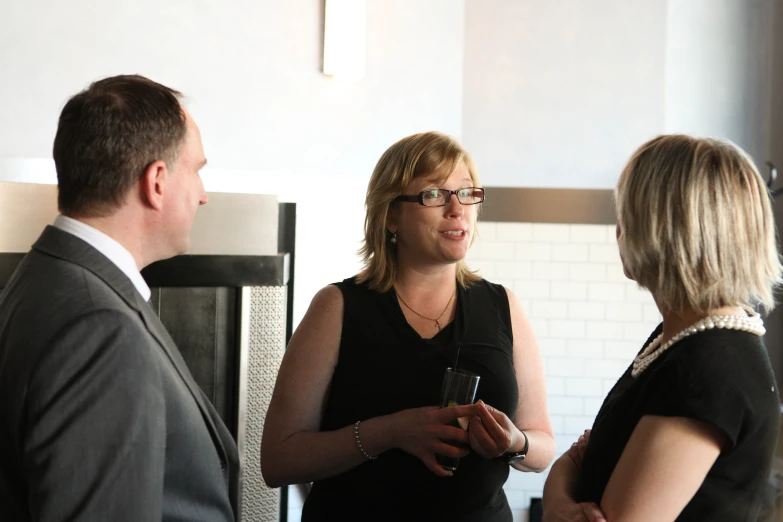 a man and woman are standing near each other talking