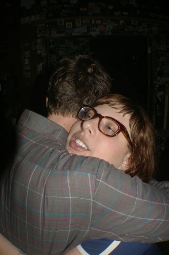 a woman who is hugging another persons shoulders