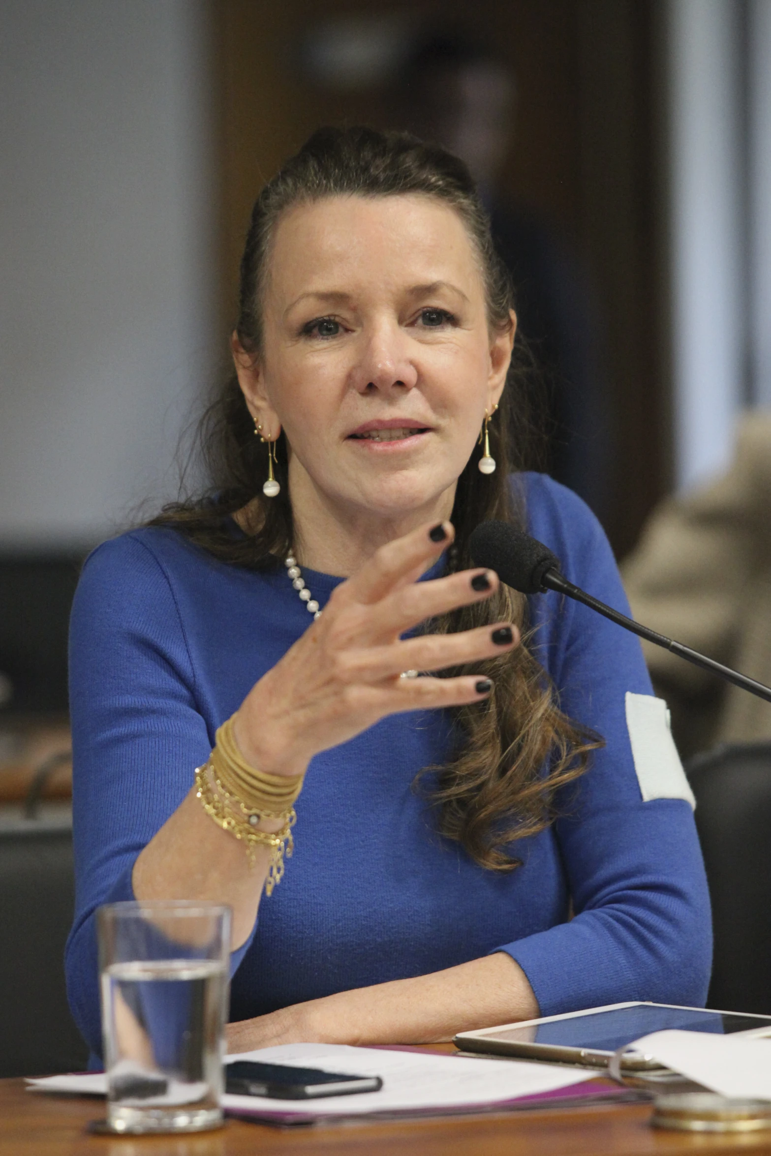 a woman holding a microphone is making a presentation