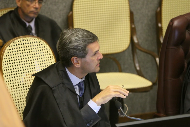 a man in suit and tie using a laptop