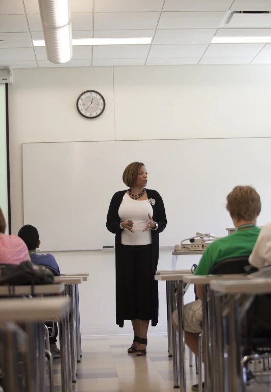 a teacher teaching with students in a classroom