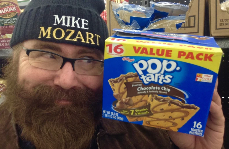 a man holding up a cardboard box of pop tarts