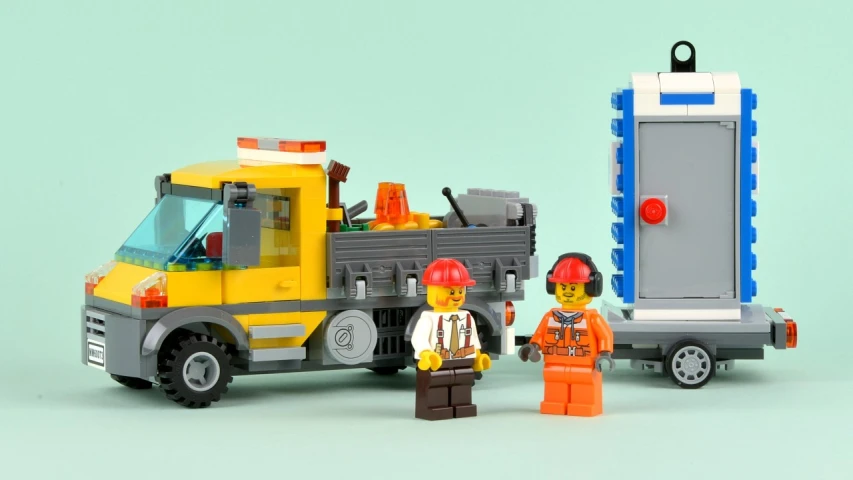 some toy people stand in front of a truck