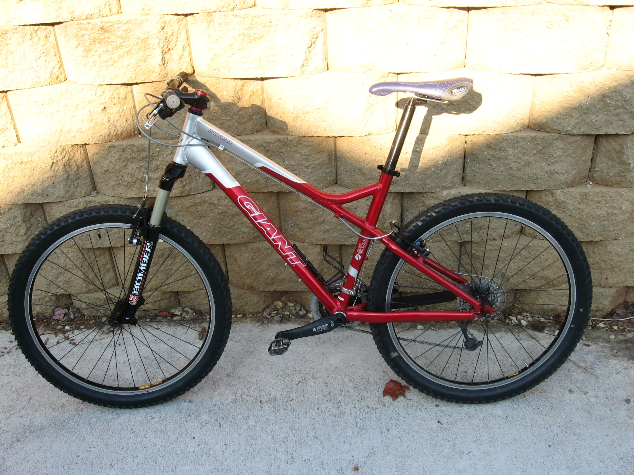 a bike is parked next to a stone wall