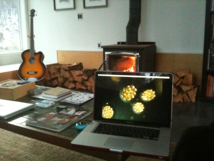 two laptops sitting in front of a fire place