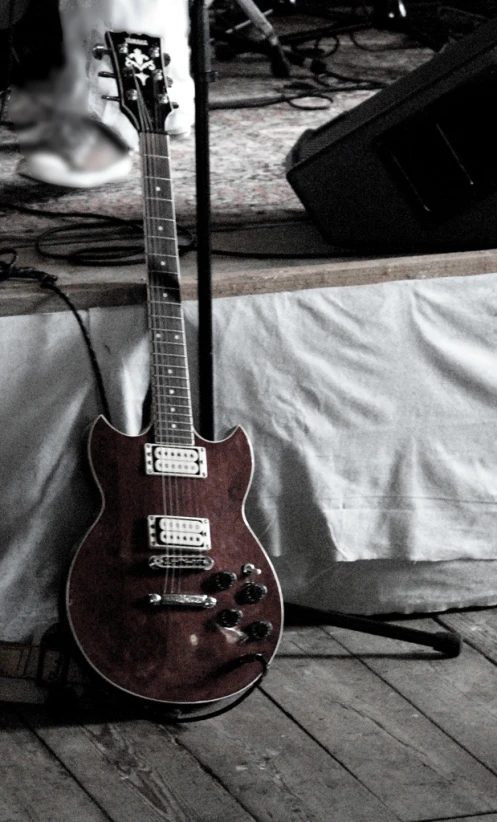 a guitar sitting on the floor next to some other musical equipment