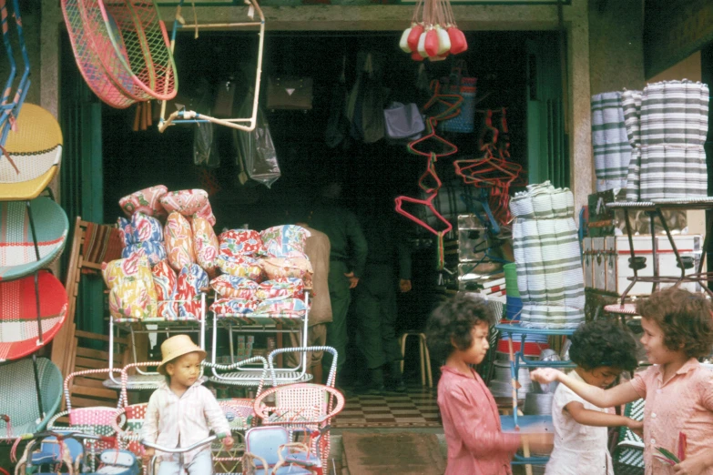 s playing in front of their store with some colorful items