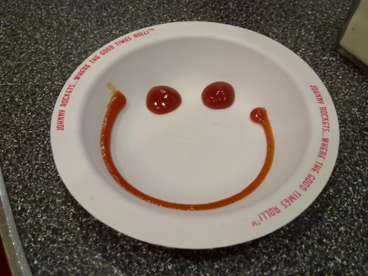 a white plate holding a smiley face drawn on it