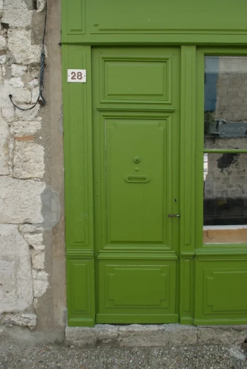 the door is green in color and has a sign on it