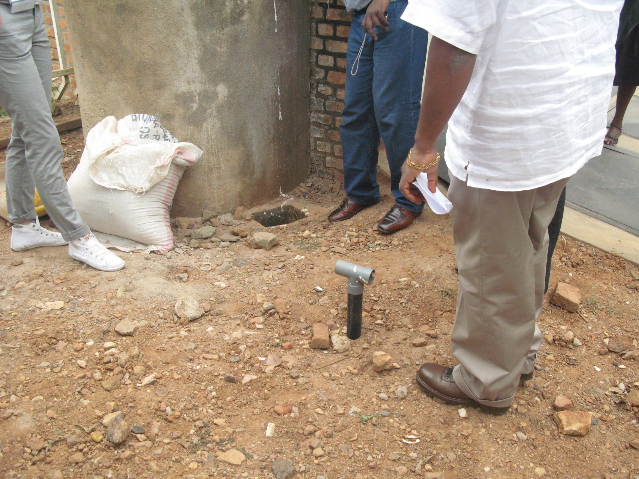 a man is putting soing in a bin on the ground