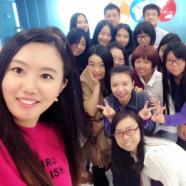 group of asian students showing victory signs for the camera