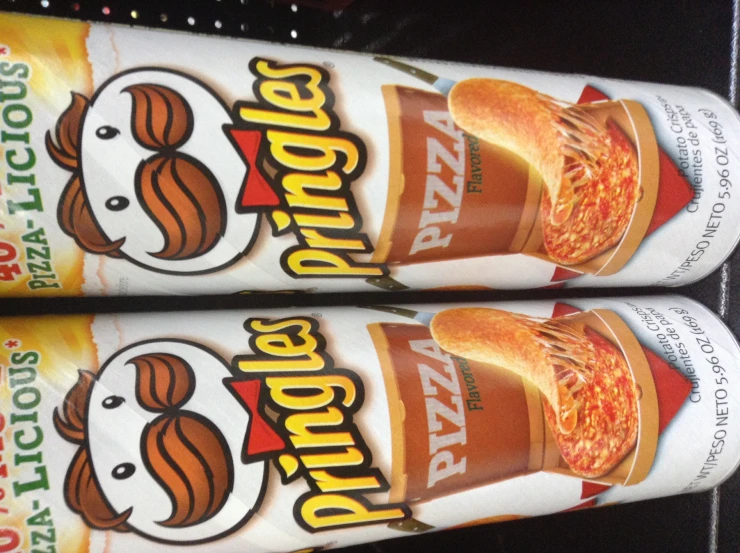 two bottles of pringles that are stacked together