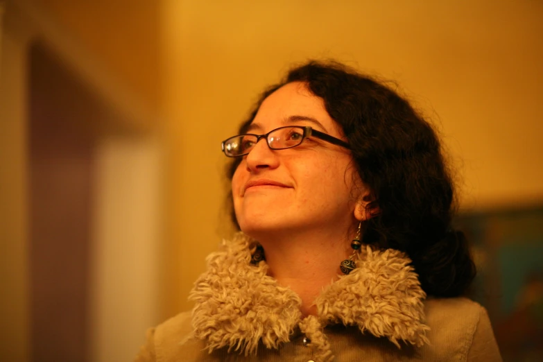 a woman wearing glasses and an animal print collar