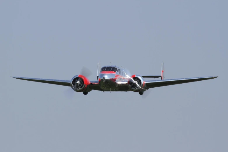 an airplane flying in the sky with its landing gear down