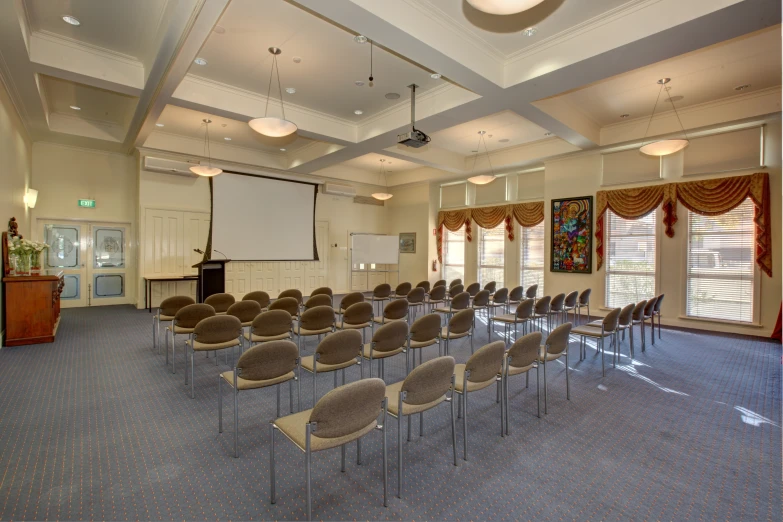 a classroom with many chairs set up in the center