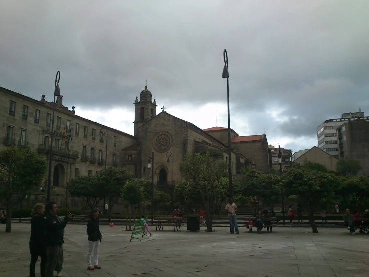 the city skyline of a large building with people around it