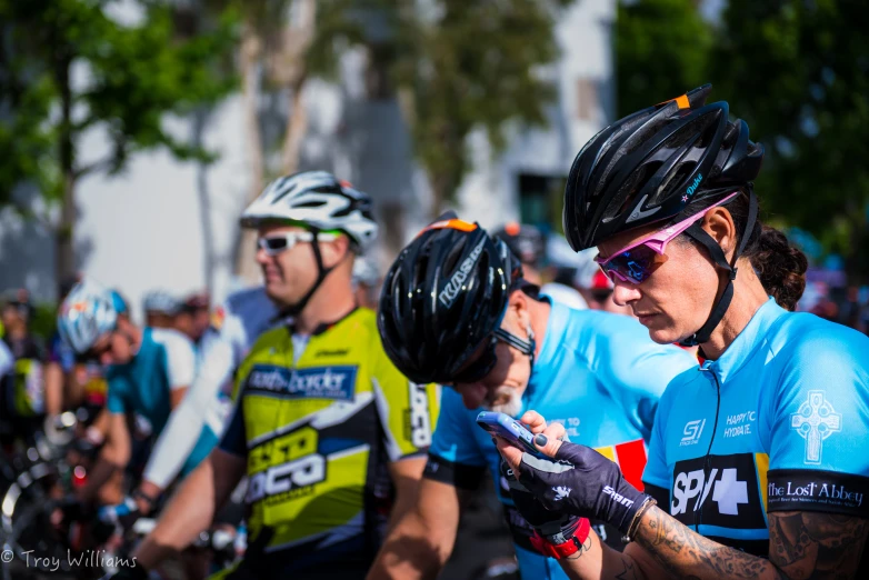 a group of bicyclists on bikes wearing helmets