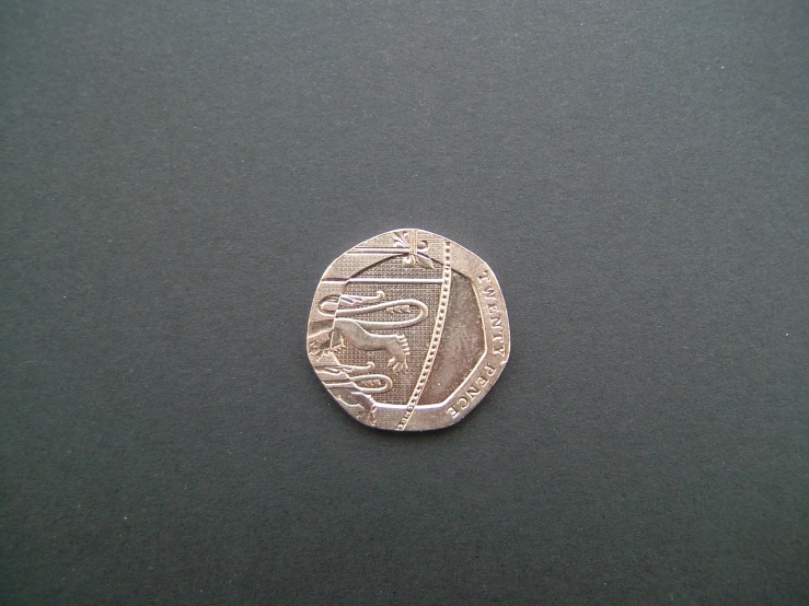 a coin is shown on the table with its cover partially open