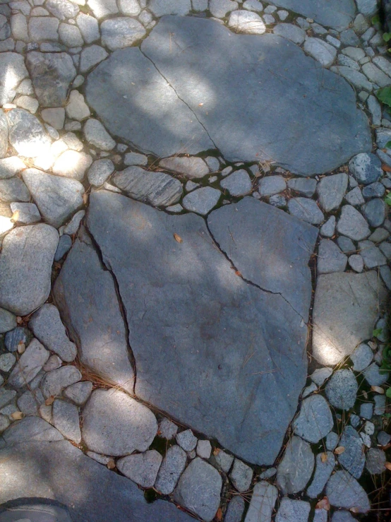 this cobble stone walkway has a heart shaped spot at the end