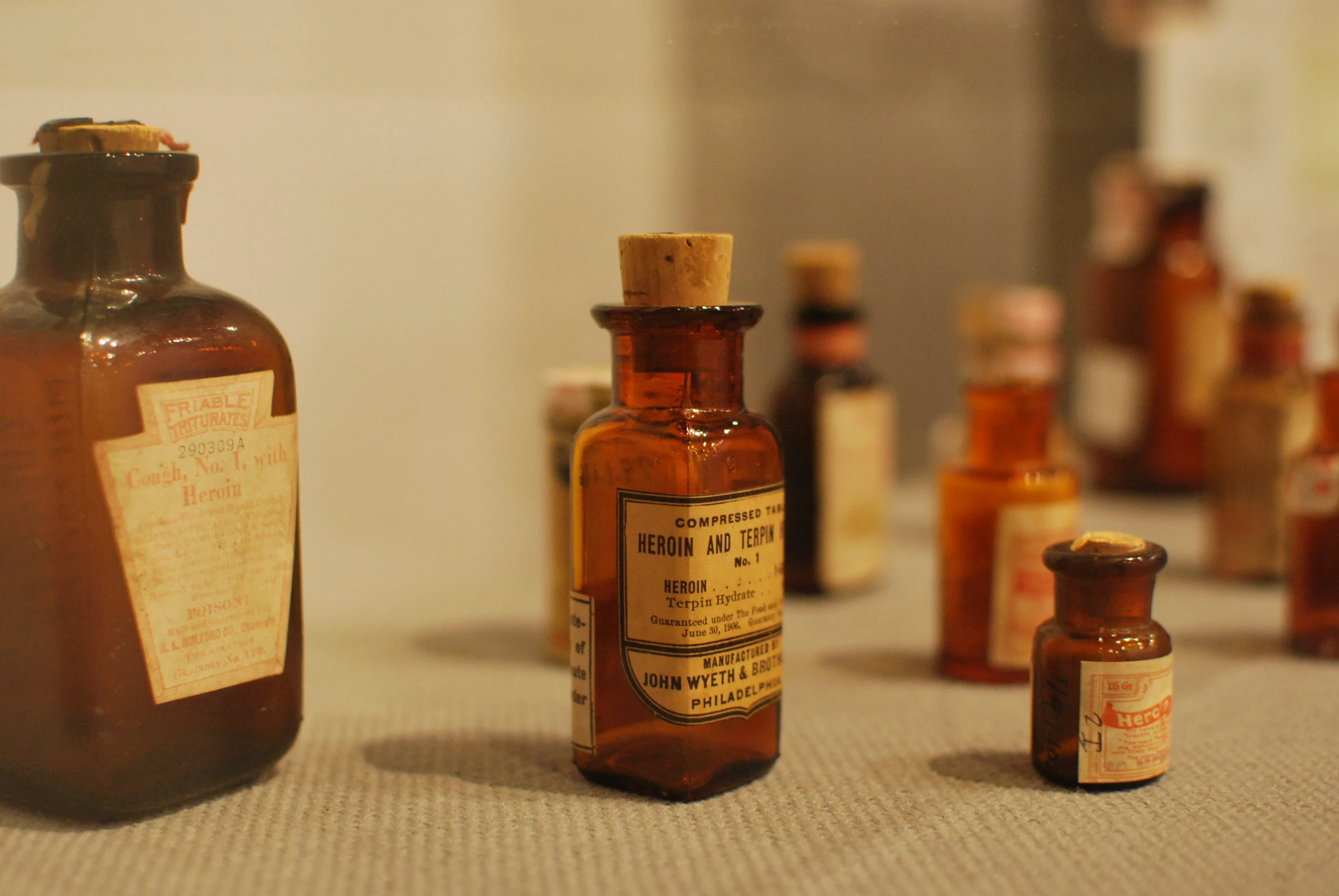 an old bottle and some tiny medicine bottles