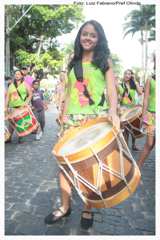 a woman holding a drum in her hand