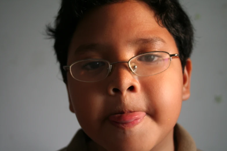 a close up of a child wearing glasses