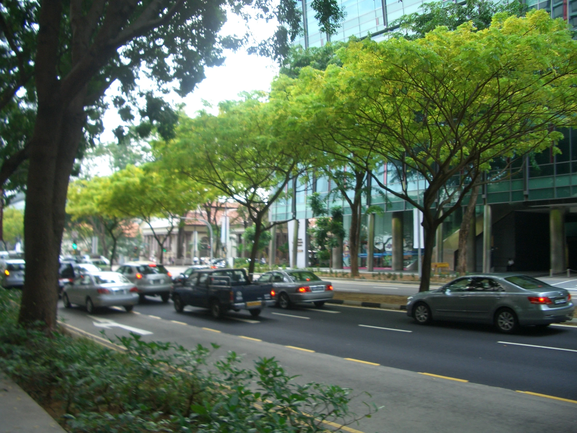 cars are moving through traffic on the city street