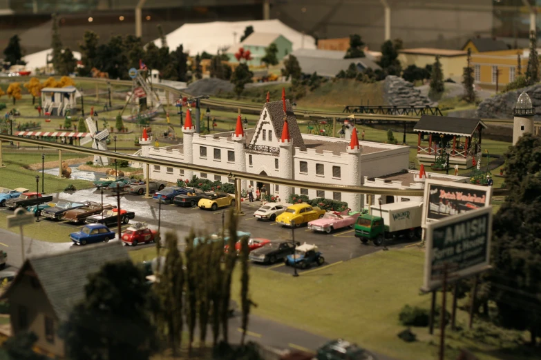 a small model of a white building with lots of traffic