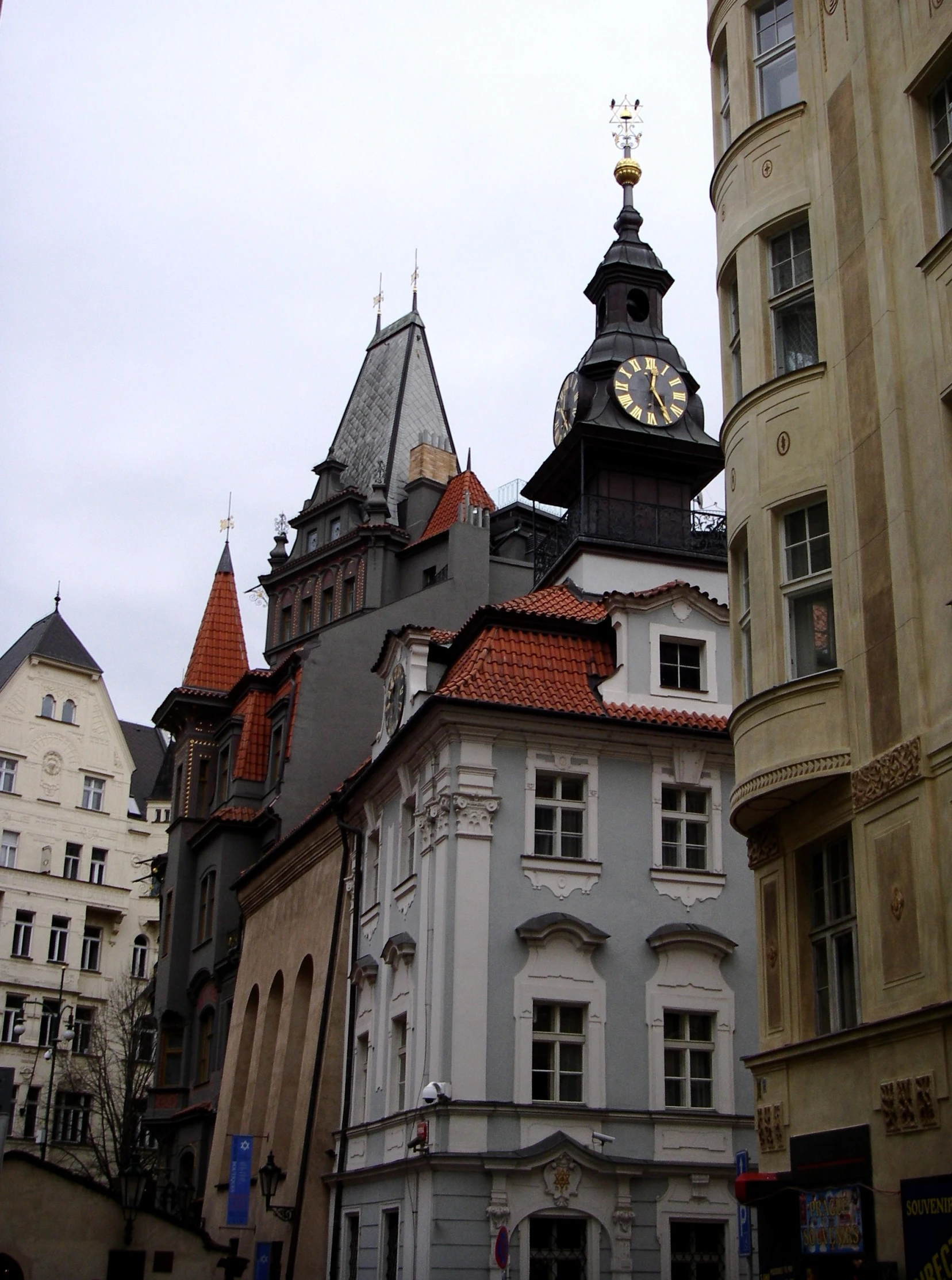 a clock tower stands in the center of a large old city