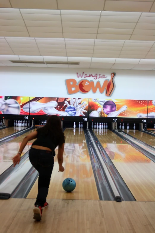 a woman is about to throw a bowling ball