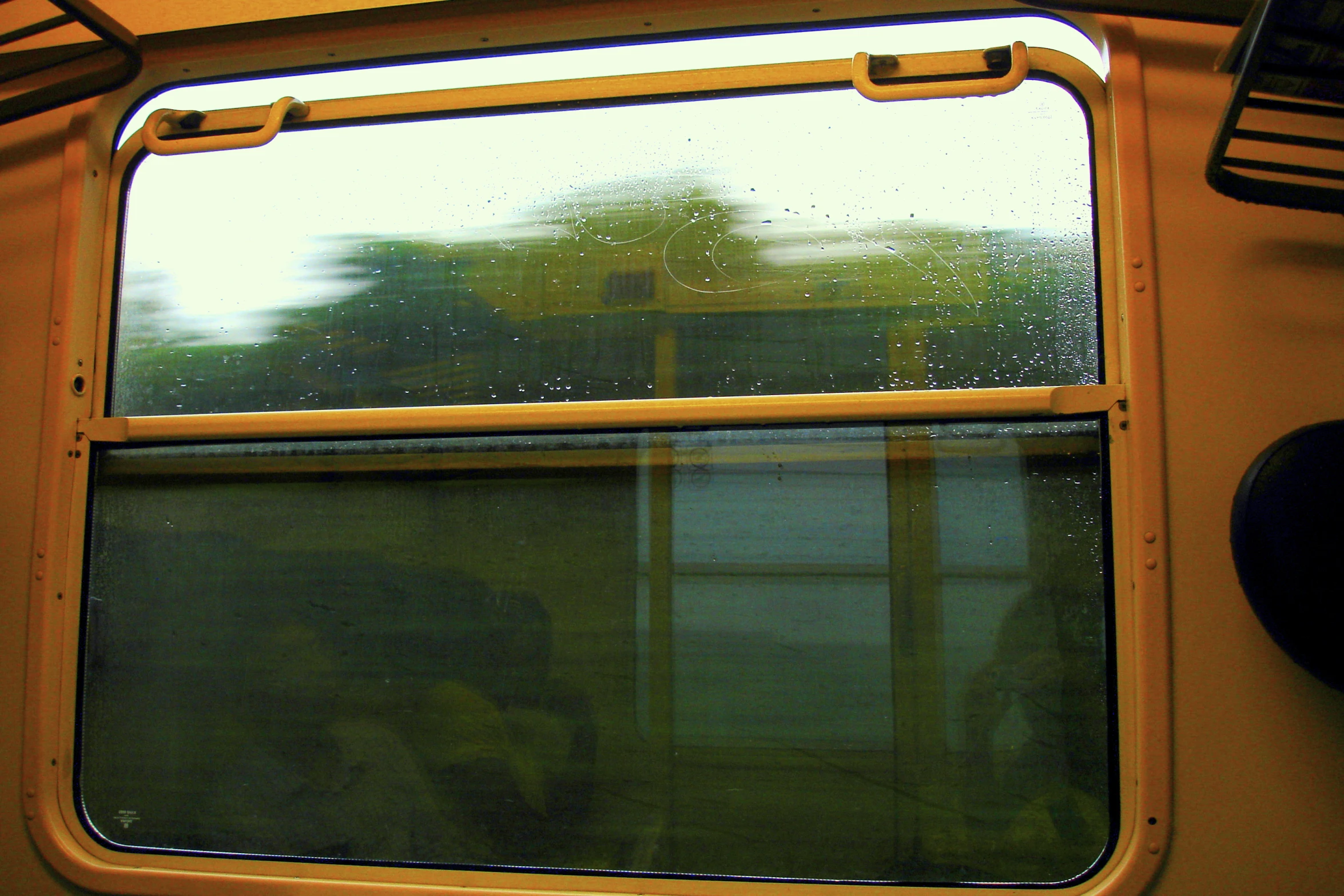 a window with an empty seat is shown through it