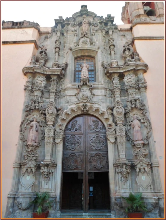 a building that has an ornate door and carvings