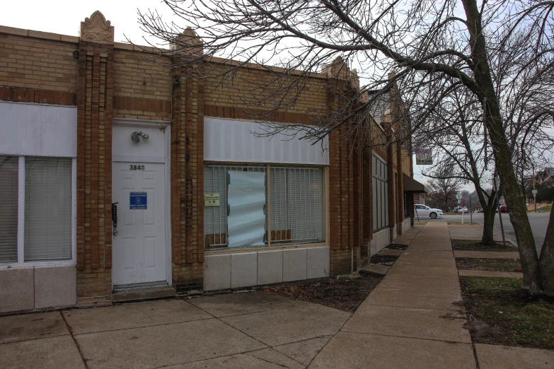 some empty shop fronts are painted white and there is no sign