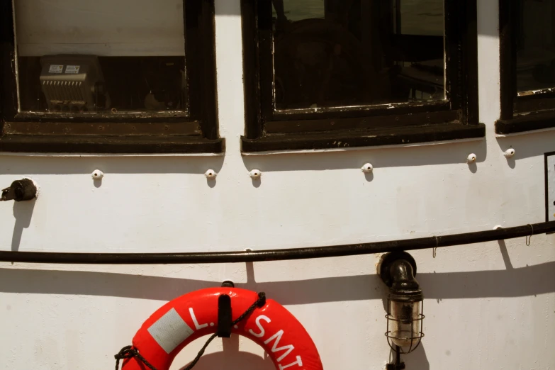 a life preserver hangs on a white boat