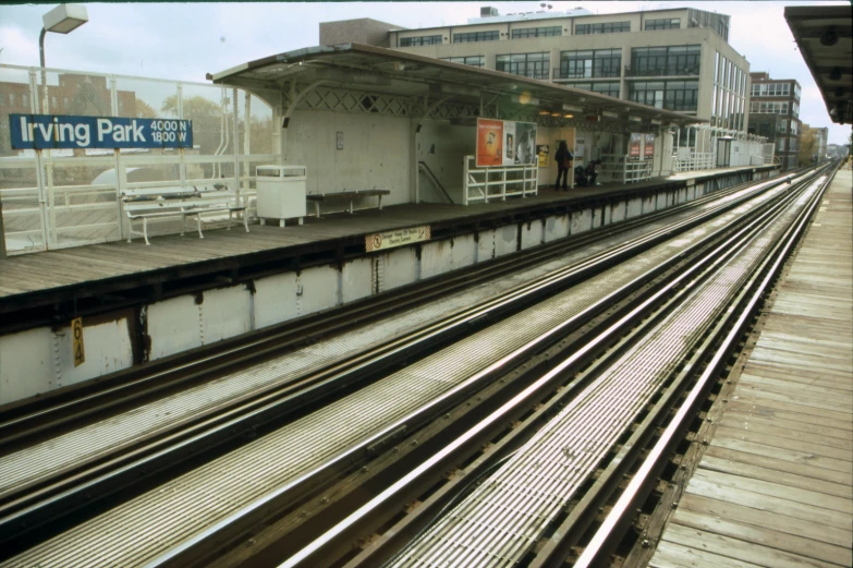 several train tracks in front of a train station