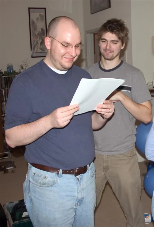 three men standing around and looking at soing