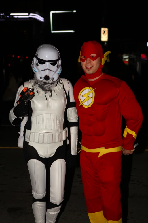 two people dressed up in costumes on the street