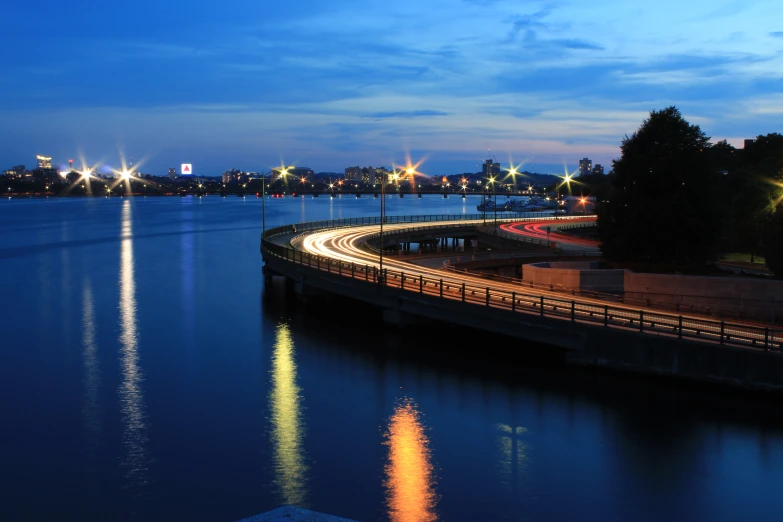 a large bridge over a body of water with a lot of lights