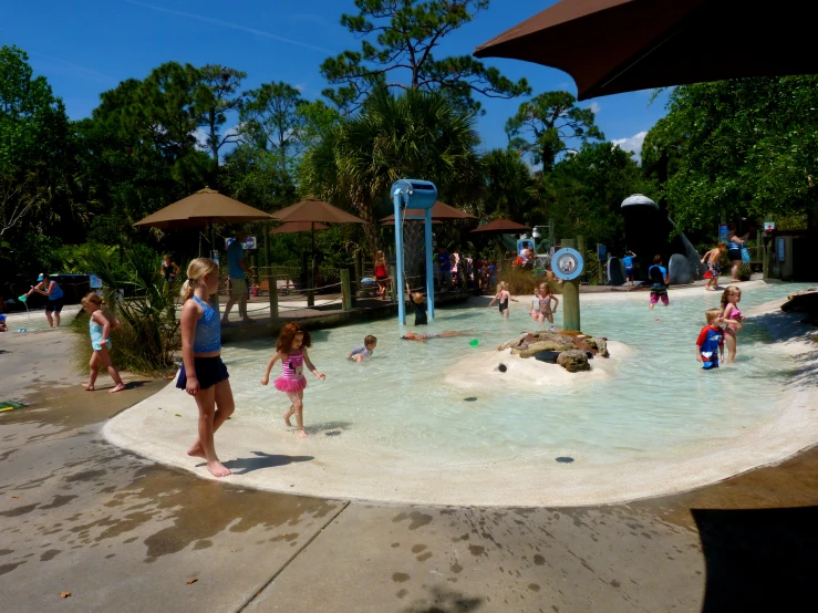 a bunch of children are playing in a water park