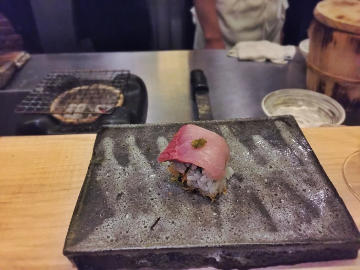 a small plate with a sushi dish is sitting on the table