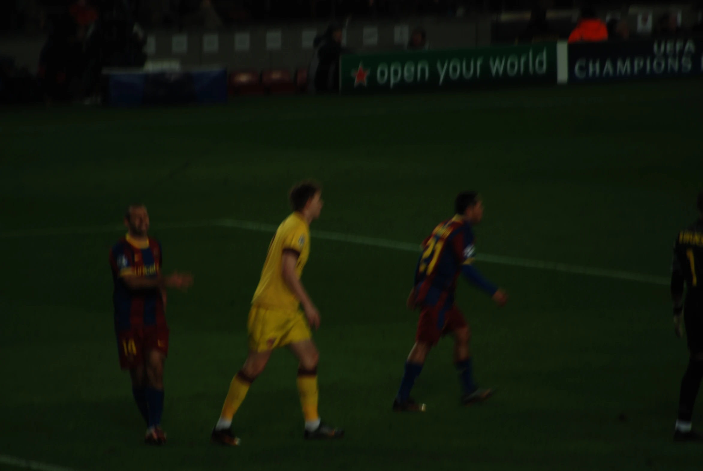 men in yellow are playing soccer on a field