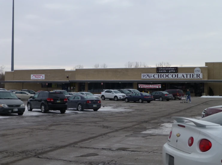 cars parked in front of a chocolate shop