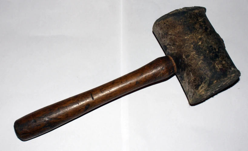 a hammer laying on top of a white background