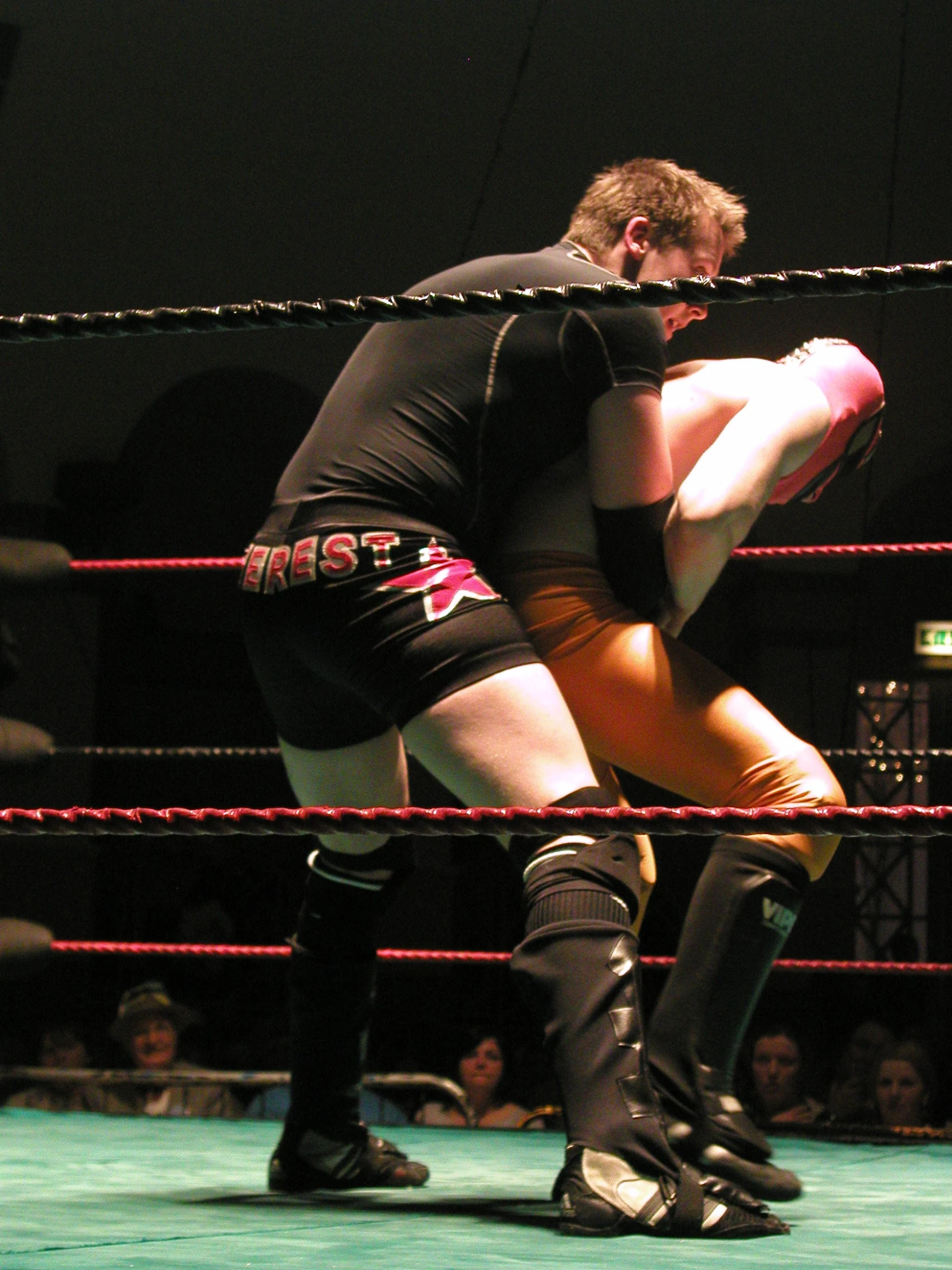 two wrestling men in tight black wrestling suits