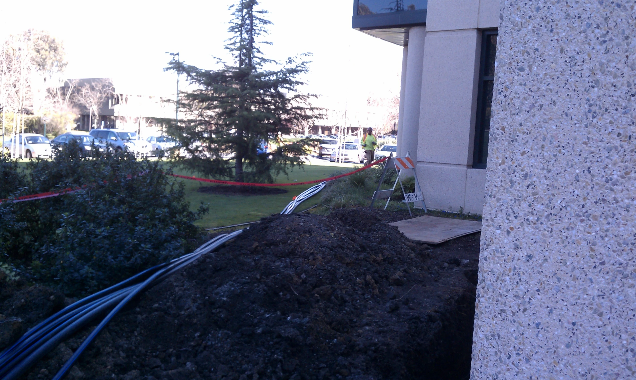 a street sign is next to a pile of compost